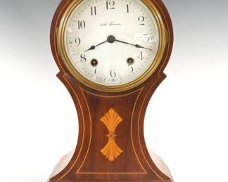 An early 20th century Seth Thomas "Parma" model mantel clock.  8-day time and strike movement with a convex porcelain dial and Arabic numerals.  Balloon form Mahogany case with contrasting stringing and inlaid detail, Brass bezel and feet.  Refinished with minor wear, running when cataloged.  12 1/4" high.  ESTIMATE $100-150