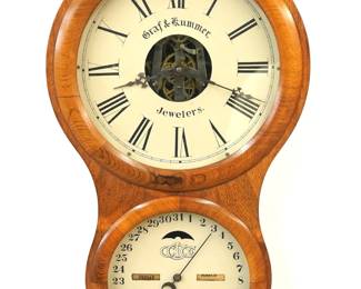 A 19th century Ithaca No. 4 Hanging Office model wall clock from "Graf & Hummer, Jewelers".  30-day dual wind spring driven time only movement and lower calendar mechanism with apertures indicating day and month, papered metal dials with Roman/Arabic numerals.  Rosewood case with a single door, two circular dial glasses and applied decoration.  Older refinishing with minor damage, re-papered dials, replaced upper hands, running when cataloged.  29" high overall . ESTIMATE $300-500