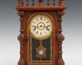 A 19th century E. N. Welch Gerster V.P. model Victorian shelf clock. 8-day time and strike movement with painted metal dial and Roman numerals, fancy pendulum with glass insert. Rosewood case with scalloped top and turned finials above a single arched door with stenciled glass, flanked by turned columns on a molded base. Paper label on back 80%. Older finish with minor wear, re-painted dial, running when cataloged. 18 1/2" high. ESTIMATE $400-600