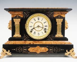 A turn of the century Seth Thomas Delos model Adamantine mantel clock.  8-day time and strike movement with papered metal dial, Roman numerals, embossed bezel.  Black Adamantine finish with marbleized detail and columns, gold metal castings.  Paper label on back 60% intact.  Case cleaned and polished with slight wear, flake in dial glass, castings re-painted, running when cataloged.  11" high.  ESTIMATE $150-200