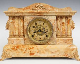 A turn of the century Seth Thomas Unlisted No. 2 model Adamantine mantel clock.  8-day time and strike movement with papered metal dial, Arabic numerals, embossed Brass door and bezel.  Marbleized Adamintine finish with gold metal castings.  Some finish wear, castings re-painted, running when cataloged.  12 3/4" high.  ESTIMATE $150-200