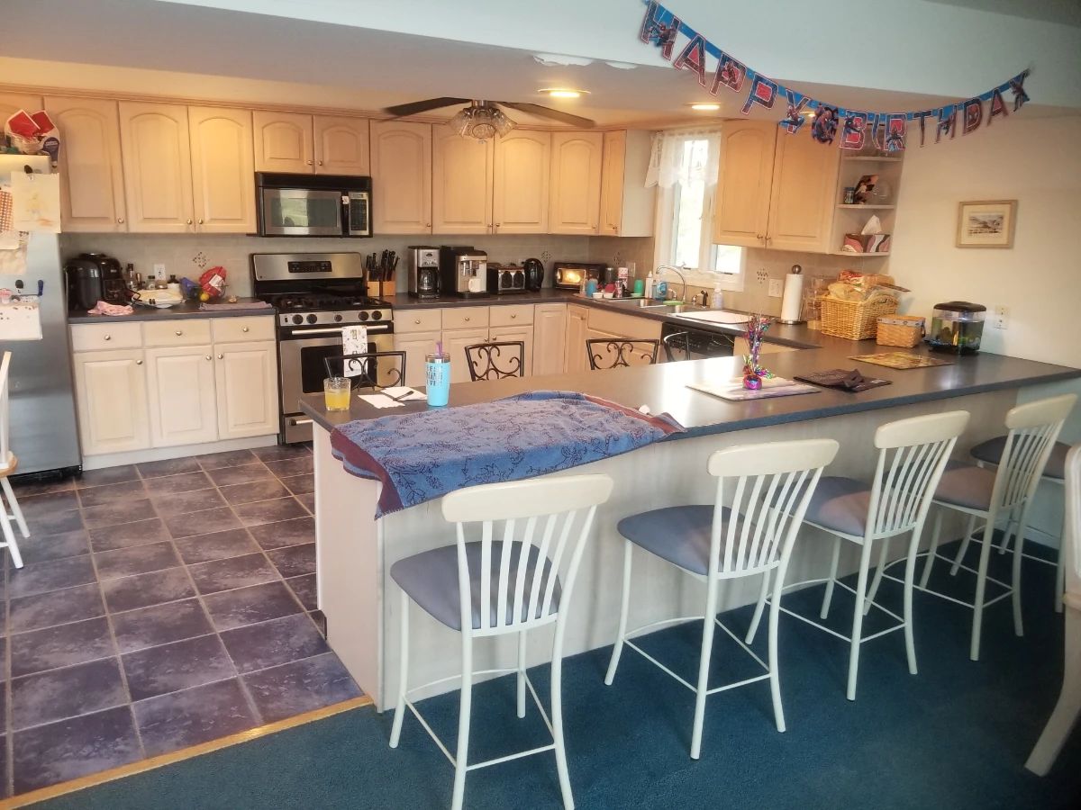 Large kitchen with plenty of cabinets; 4 bar stools