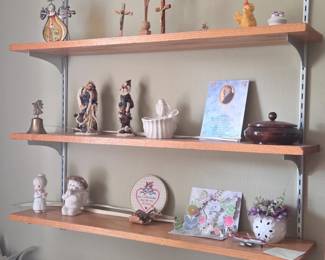 Assorted religious decor collection on wooden shelves