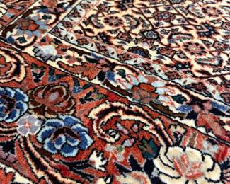 Rich jewel tones, intricate floral motifs, and exceptional craftsmanship come together in this beautifully handwoven Persian-style rug.