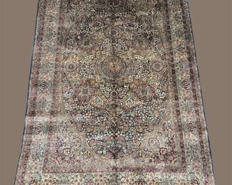 Soft neutral rug with a faded floral pattern and a relaxed, vintage-inspired appearance.