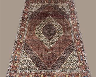 Geometric medallion rug in warm rust, brown, and neutral tones.