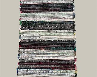 Contemporary striped flatweave rug in neutral black, gray, and ivory tones. A versatile design that works beautifully in living rooms, bedrooms, or offices.