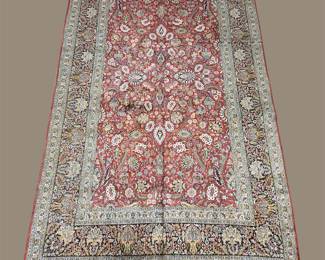 Soft red and ivory rug with a delicate repeating pattern and traditional border work.
