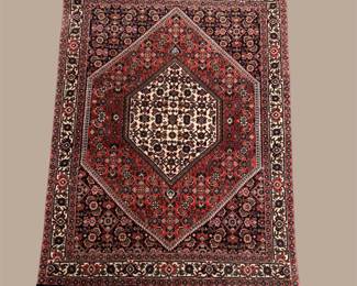 Traditional Persian-inspired rug featuring a striking central medallion and intricate floral details. A sophisticated addition to any room.