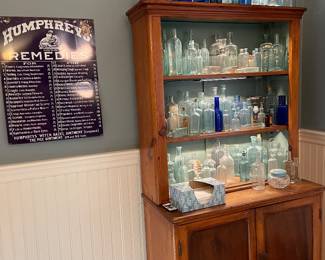 Large collection of antique patent medicine bottles and advertising
