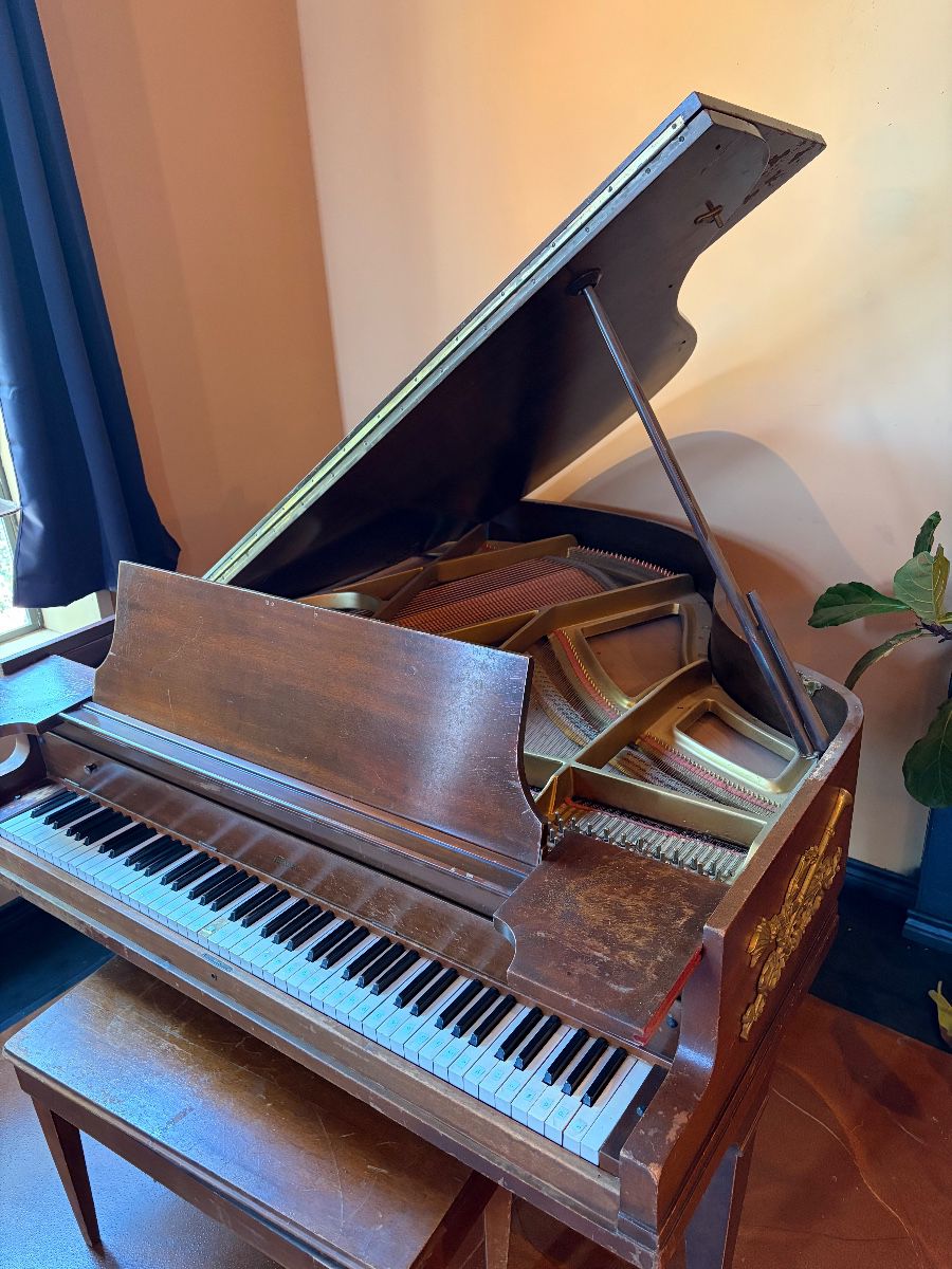 Baby grand piano and bench