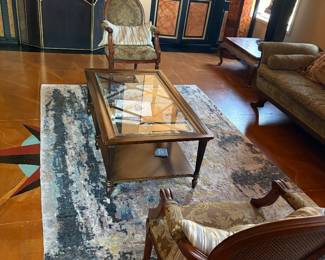 Two upholstered chairs, a coffee table and rug