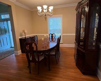 Cherry Dining room table with 2 armchairs and four regular chairs with custom table pads included. Two leaves and table extends to 120”