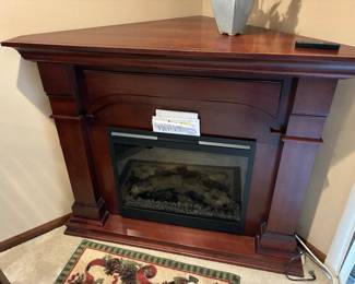 Electric fireplace by Dimplex for the corner. 54” wide x 30” deep from the front to the back corner x 42” high. Comes with remote.