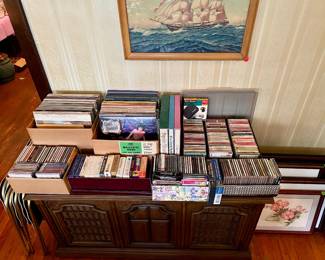 Record player, records, CDs and framed art