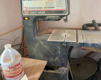 Craftsman 12-inch band saw and sander combination on stand. Heavy-duty woodworking machine with adjustable worktable, ideal for curved cuts, shaping and sanding projects.