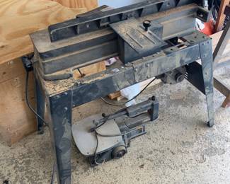 Craftsman jointer/planer on a metal stand, used for flattening and straightening boards and creating smooth, square edges. Craftsman scroll saw included beneath the stand.