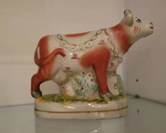 Staffordshire style cow figurine