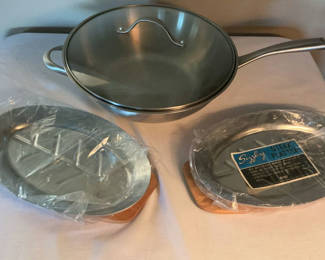 Lot 38: Stainless steel cookware set with frying pan, glass lid, and steak plates