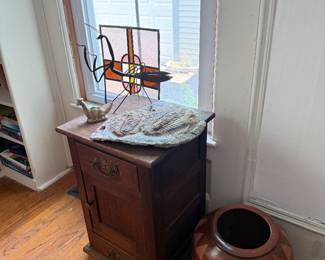 Library-wooden stand, large pottery vase, trilobite fossil, stained glass window, metal praying mantis