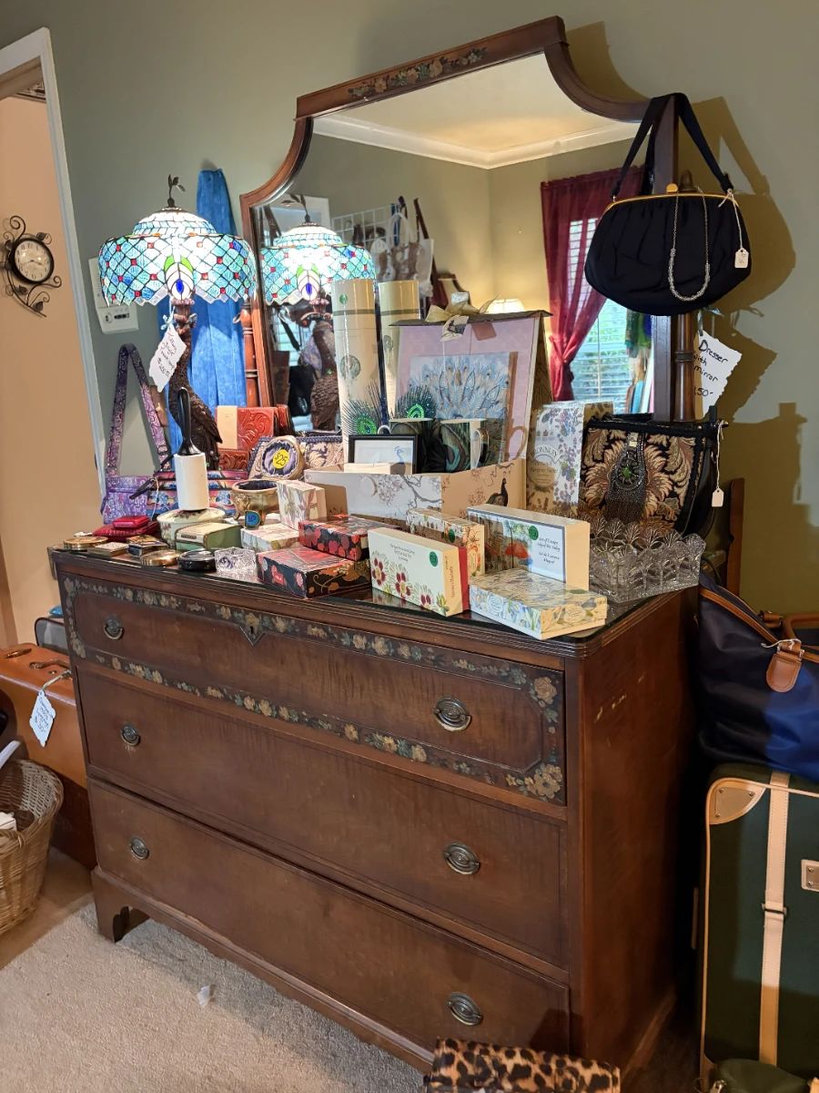 E dresser  mirror, stained glass lamp, luggage, perfume