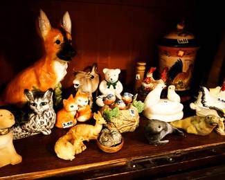E animal figurines inside antique cabinet
