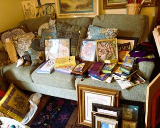 Ea Couch full of books, frames, pillows