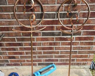 This is an Orbit ornamental sprinkler featuring a copper-plated finish and decorative spinning spiral rings