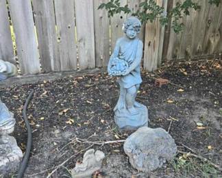 weathered garden statue holding a basket of fruit