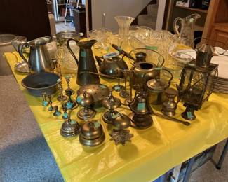 Variety of brass items….bells, candlesticks, pitchers, water can,