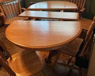 Amish oak table with two leaves and six chairs: four side and two captain. Presale available at $375