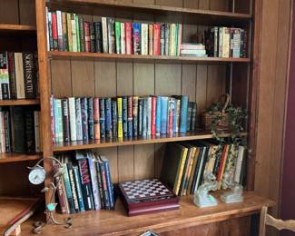Collection of books, chess set, bookends