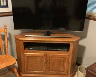 Oak corner tv stand with shelf for additional units and cabinet for storage. Presale $120 also a Samsung tv