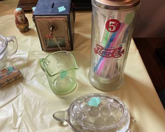 Vintage items: green depression glass measuring cup, Pepsi straw holder, metal bank with key, and glass turtle dish with lid