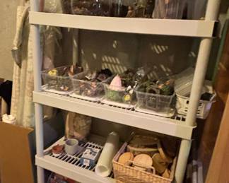 Collection of Miniature Fairy Garden Accessories and Craft Supplies on Shelving Unit