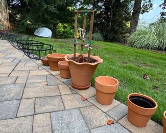 Assorted Terracotta Garden Planters, Wire Baskets, and Wooden Trellis