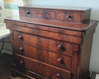 In mid 1800s chest of drawers with original finish and hand cut dovetails
