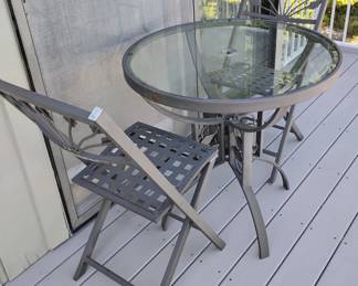 An unsigned wrought iron patio set attributed to Brown Jordan