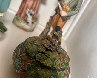 Vintage cloisonné hummingbird trinket box is a hand-crafted metal and enamel collectible typically featuring colorful floral motifs, gold-wire details