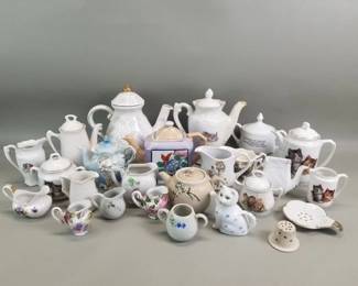 Lot 490  Group of porcelain and ceramic teapots, cream a