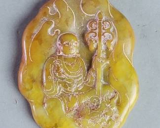 124  Lot 289  Carved jade pendant depicting a Buddhist monk