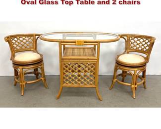 Lot 552 3pc Rattan and Cane Bistro Set with Oval Glass Top Table and 2 chairs
