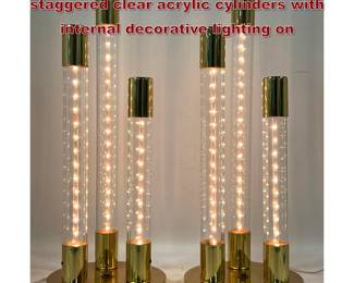 Lot 375 Pair table lamps featuring 3 staggered clear acrylic cylinders with internal decorative lighting on 