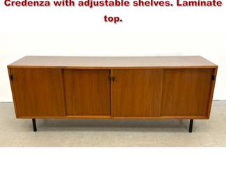 Lot 49 Florence Knoll Leather Pull Walnut Credenza with adjustable shelves. Laminate top. 