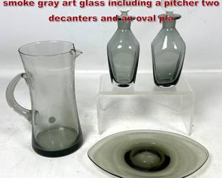 Lot 1150 4pc set of Kastrup Holmegaard smoke gray art glass including a pitcher two decanters and an oval pla