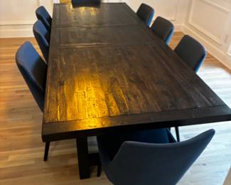8 unholstered chairs with a very nice table with 2 leafs