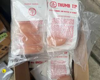 Box full of vintage magic thumb trick 