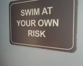 Swim at your own risk sign