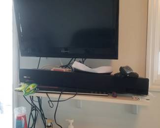 TV with bracket; LG DVD player; sound bar