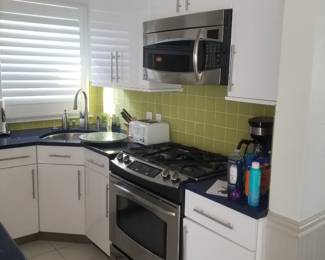 Kitchen is L-shaped with an island. GE microwave oven mfg. 5/2009